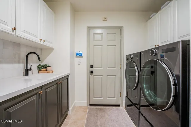 a kitchen with a dining table chairs appliances and cabinets