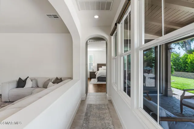 a bedroom with a bed and a potted plant