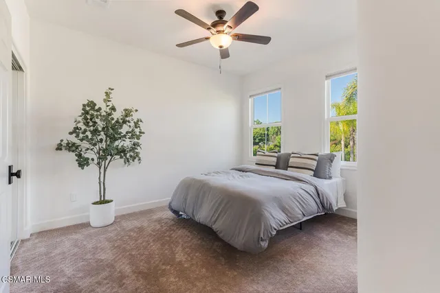a view of a patio with a table and chairs under an umbrella