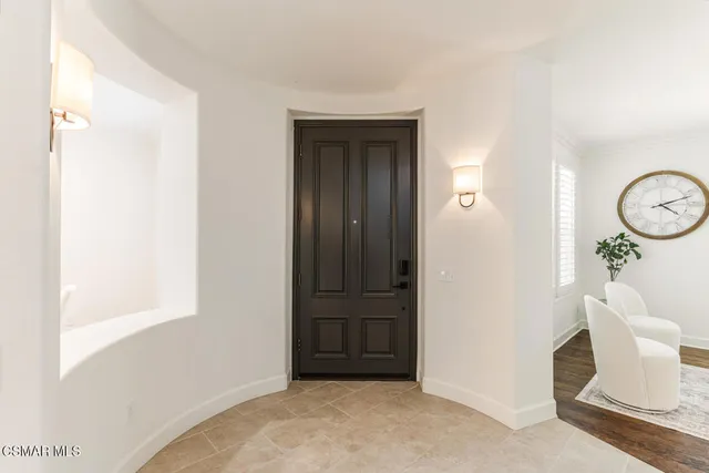 a living room with furniture potted plant and a window