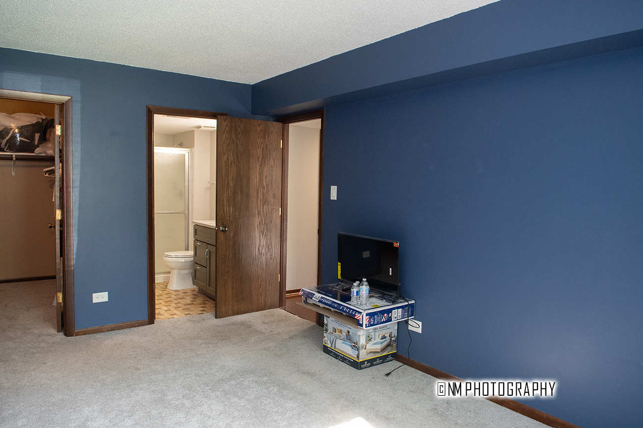 9182 S Road, Unit A Palos Hills, IL 60465 - Photo 11 of 16 a living room with furniture a flat screen tv and a window