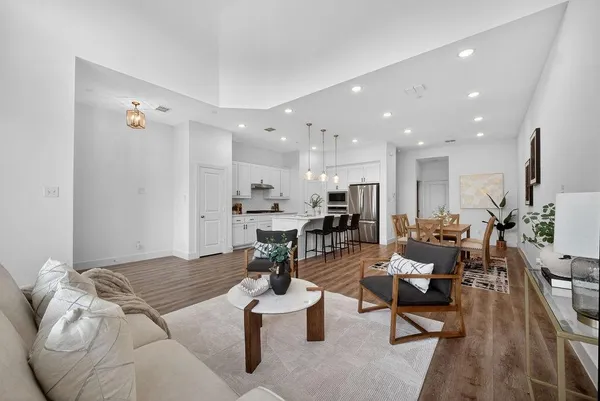 a living room with furniture and view of kitchen