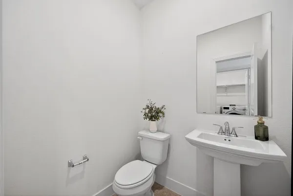 a bathroom with a sink mirror and toilet