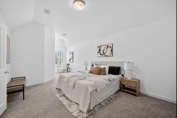 a bedroom with a bed and a lamp