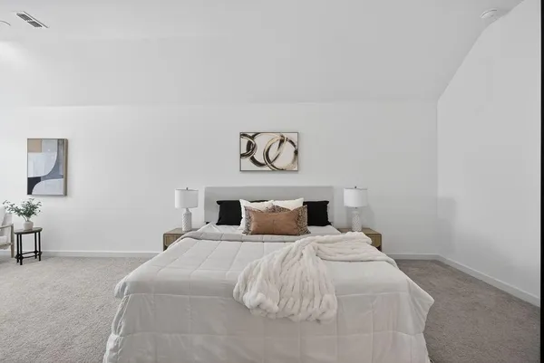 a bedroom with a bed and a table