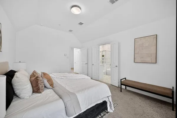 a bedroom with a bed and a chair