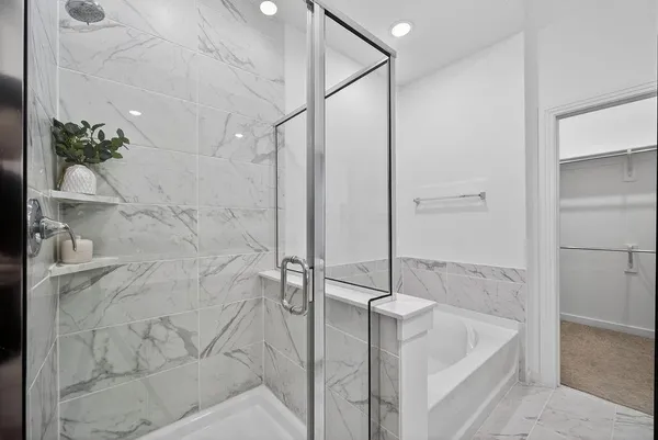 a bathroom with a tub and shower
