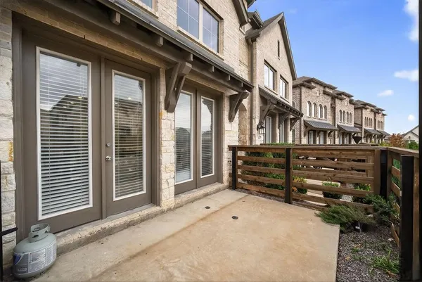 a view of a house with a wooden fence