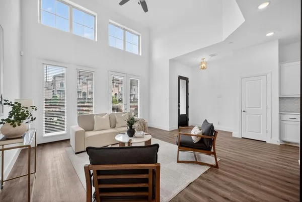 a living room with furniture and wooden floor