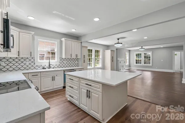 a kitchen with sink stove and cabinets