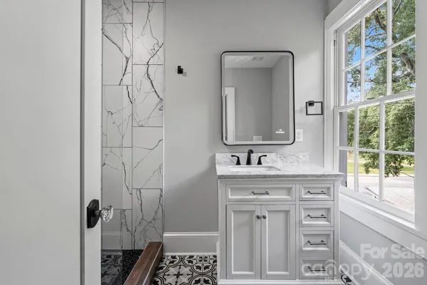 a bathroom with a sink and a mirror