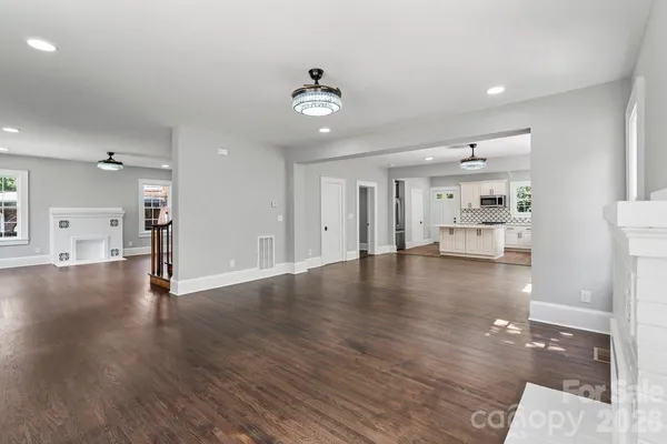 a view of kitchen and hall with wooden floor