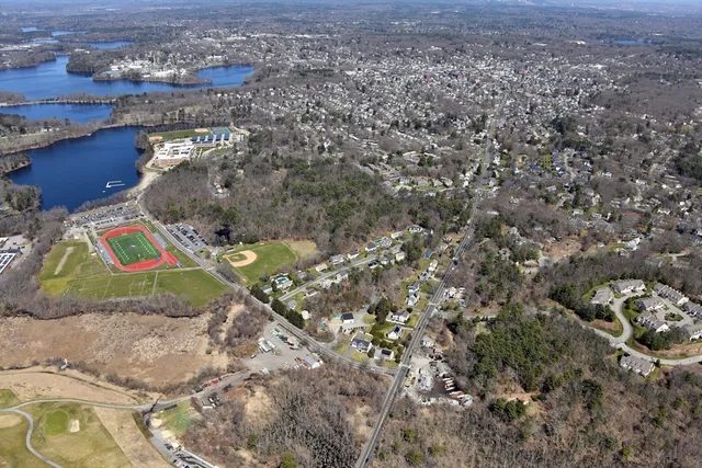 an aerial view of a house with a yard