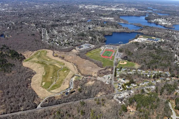 an aerial view of a house with a yard basket ball court