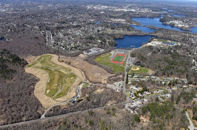an aerial view of a house with a yard basket ball court