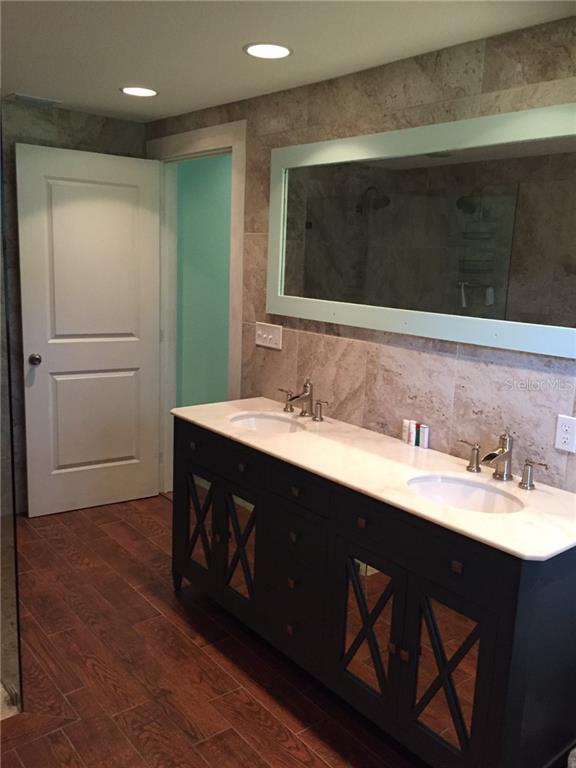 Undisclosed Address Bradenton, FL 34208 - Photo 11 of 13 a bathroom with a double vanity sink and mirror