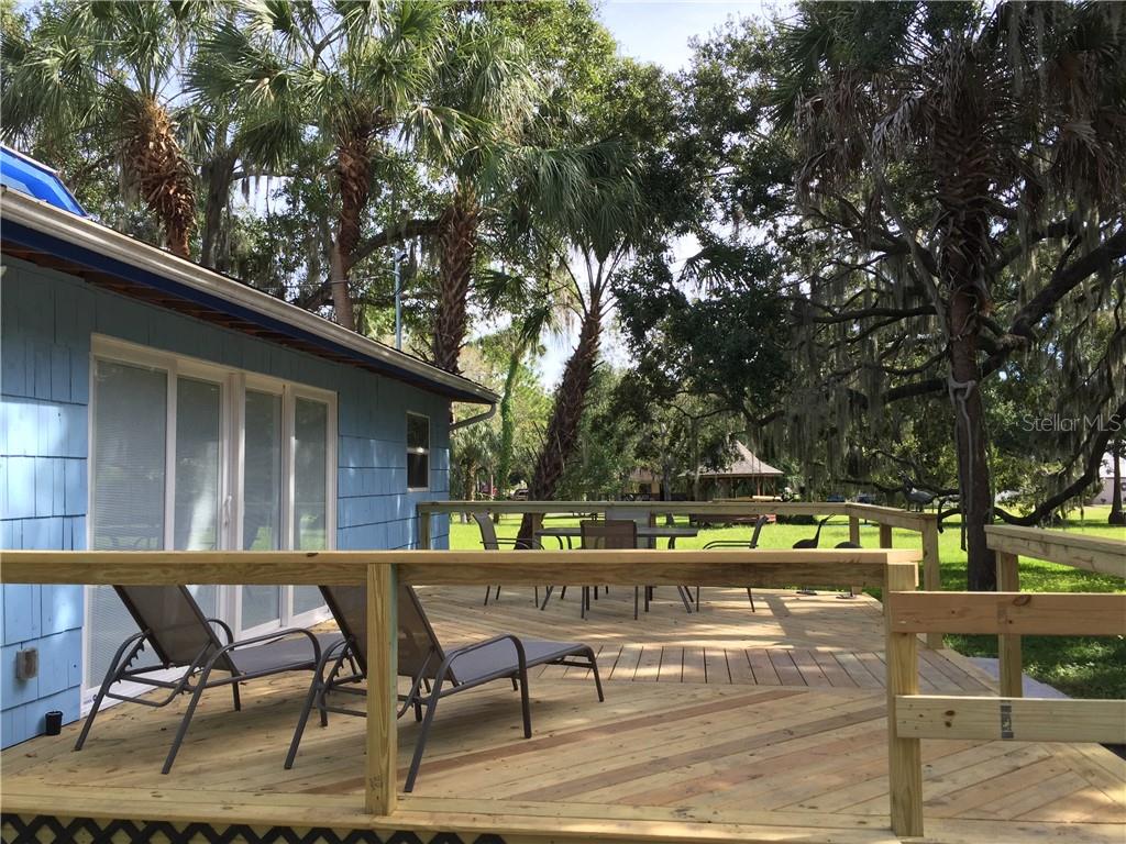 Undisclosed Address Bradenton, FL 34208 - Photo 12 of 13 a backyard of a house with barbeque oven and outdoor seating