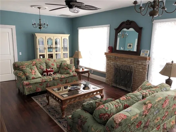a living room with furniture and a fireplace