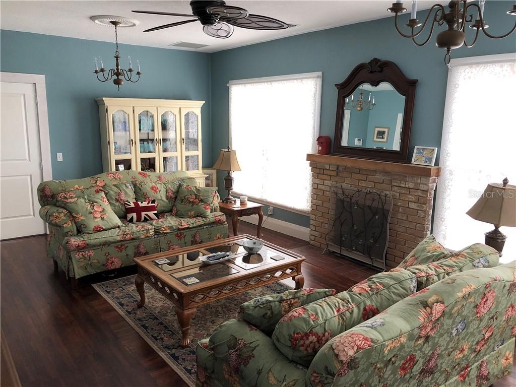 Undisclosed Address Bradenton, FL 34208 - Photo 3 of 13 a living room with furniture and a fireplace