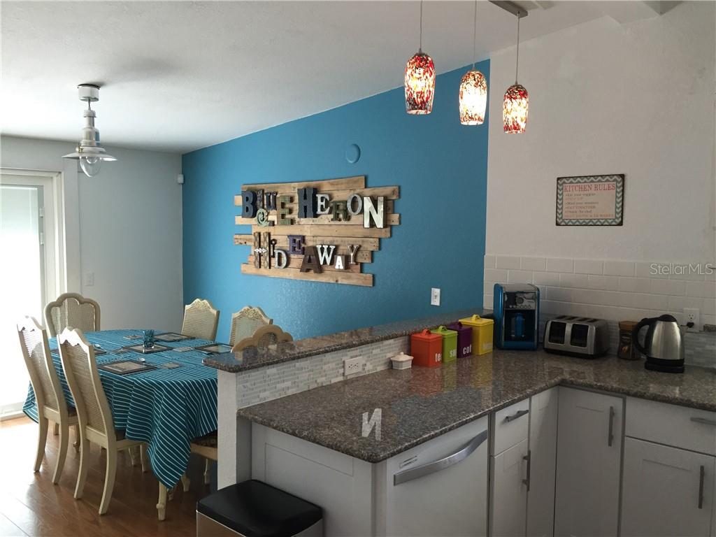 Undisclosed Address Bradenton, FL 34208 - Photo 7 of 13 a kitchen with a table chairs and cabinets