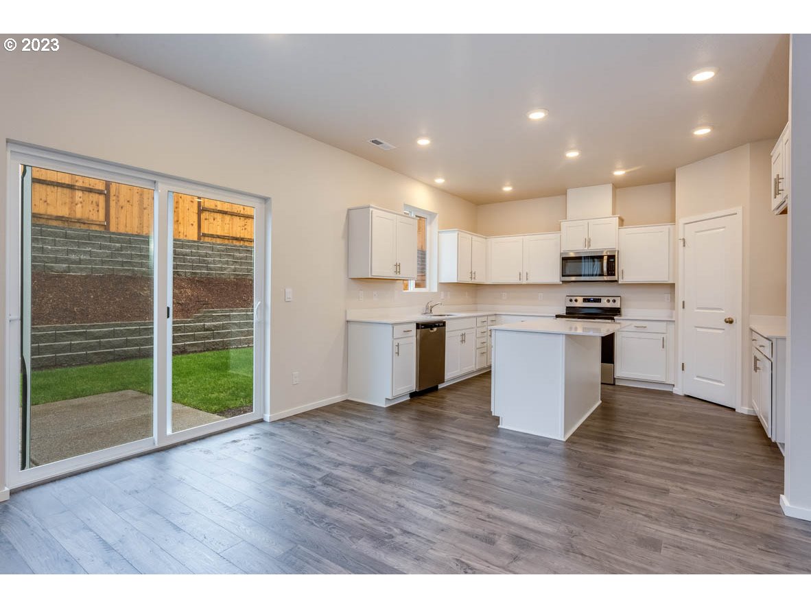 3217 Southeast 35th Street Gresham, OR 97080 - Photo 11 of 30 a view of kitchen with granite countertop stainless steel appliances counter space and wooden floor