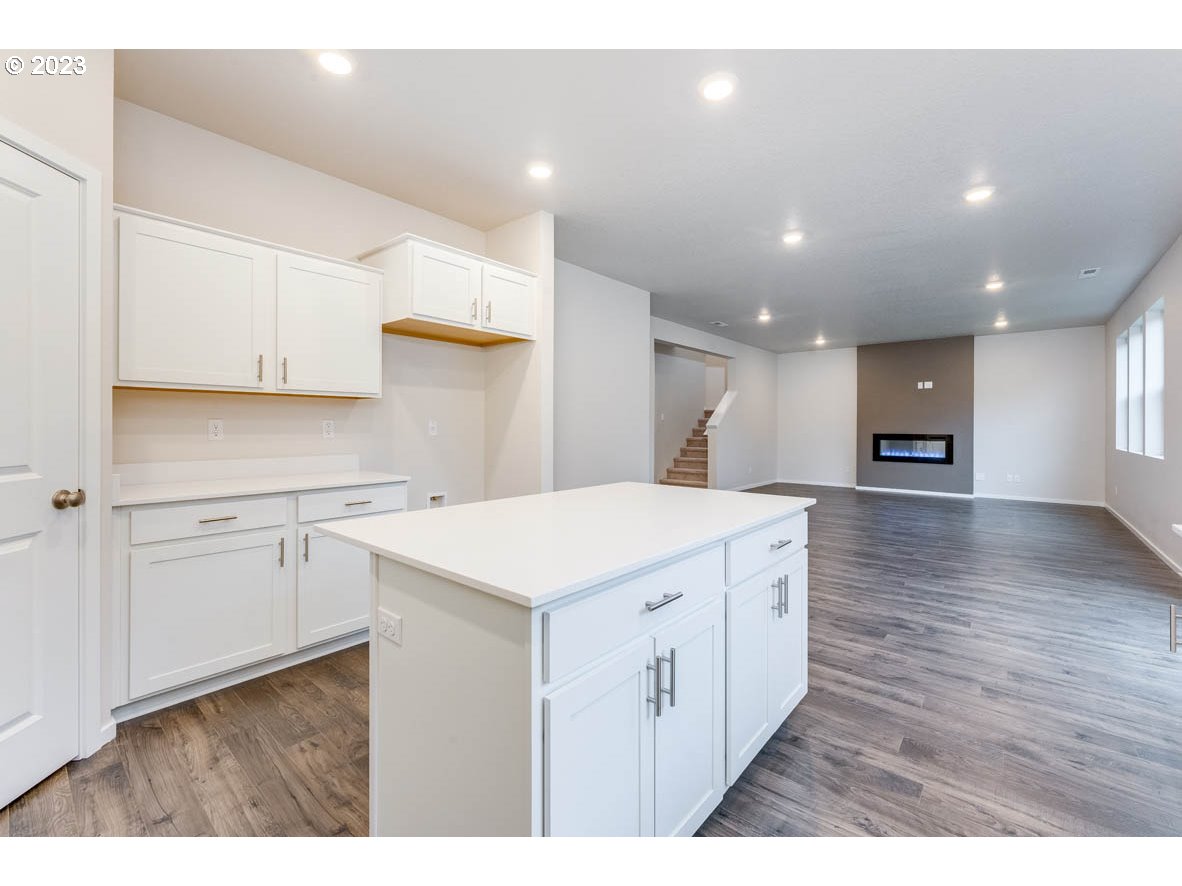 3217 Southeast 35th Street Gresham, OR 97080 - Photo 15 of 30 a kitchen that has a lot of white cabinets and wooden floor