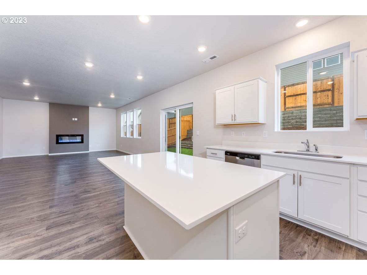 3217 Southeast 35th Street Gresham, OR 97080 - Photo 16 of 30 a kitchen with a sink a wooden floor and a large window
