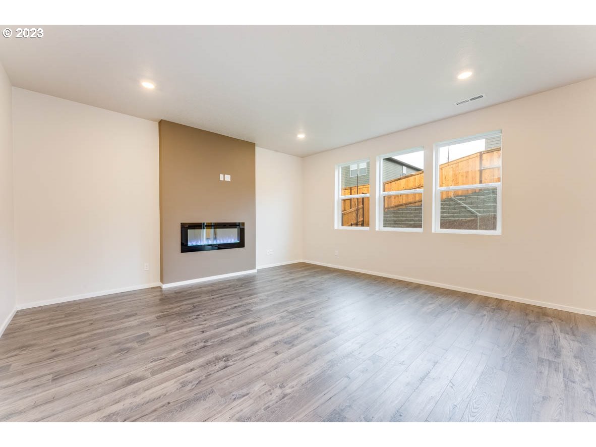 3217 Southeast 35th Street Gresham, OR 97080 - Photo 7 of 30 a view of an empty room with wooden floor and a window