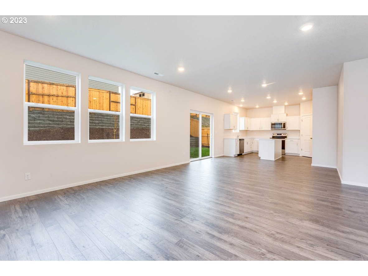 3217 Southeast 35th Street Gresham, OR 97080 - Photo 9 of 30 a view of an empty room with wooden floor and a window