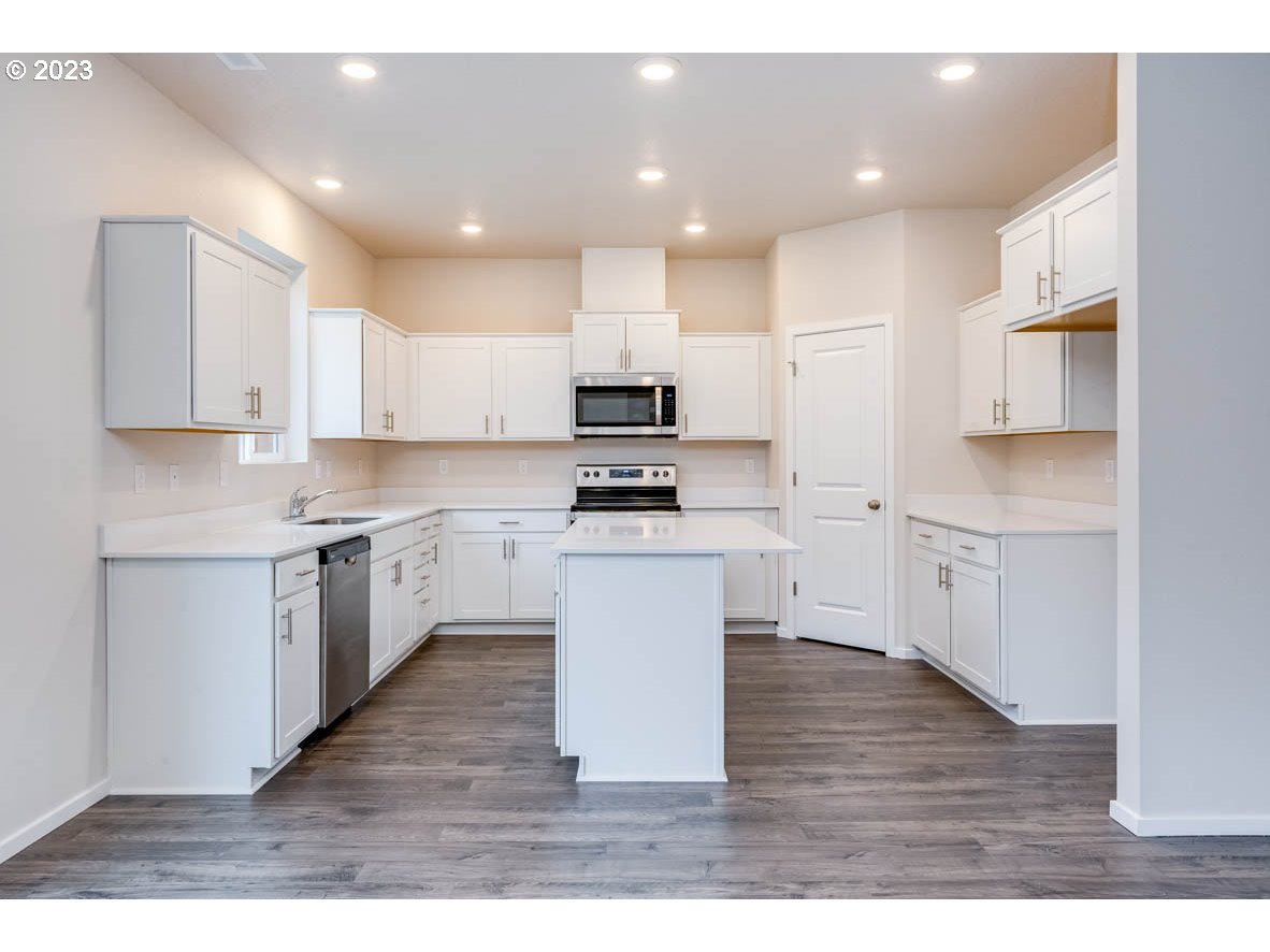 3217 Southeast 35th Street Gresham, OR 97080 - Photo 10 of 30 a kitchen with granite countertop a stove top oven sink and cabinets