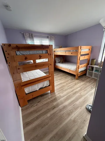 a view of room with wooden floor and furniture