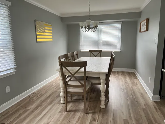 a view of a dining room with furniture wooden floor and chandelier