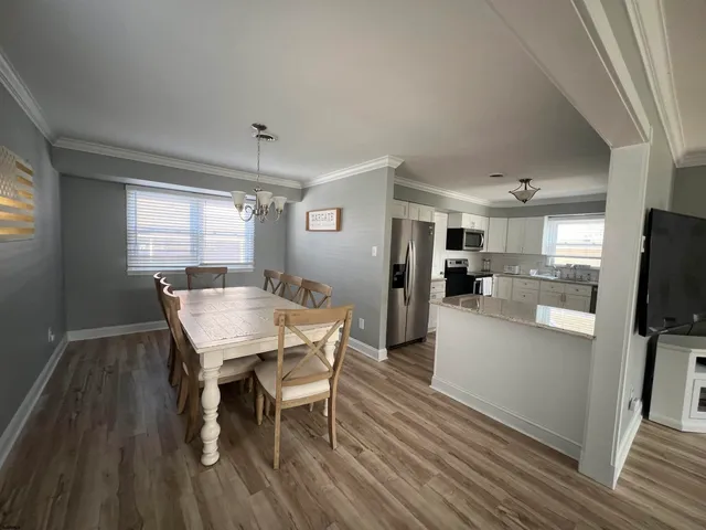 a view of a dining room with furniture and wooden floor