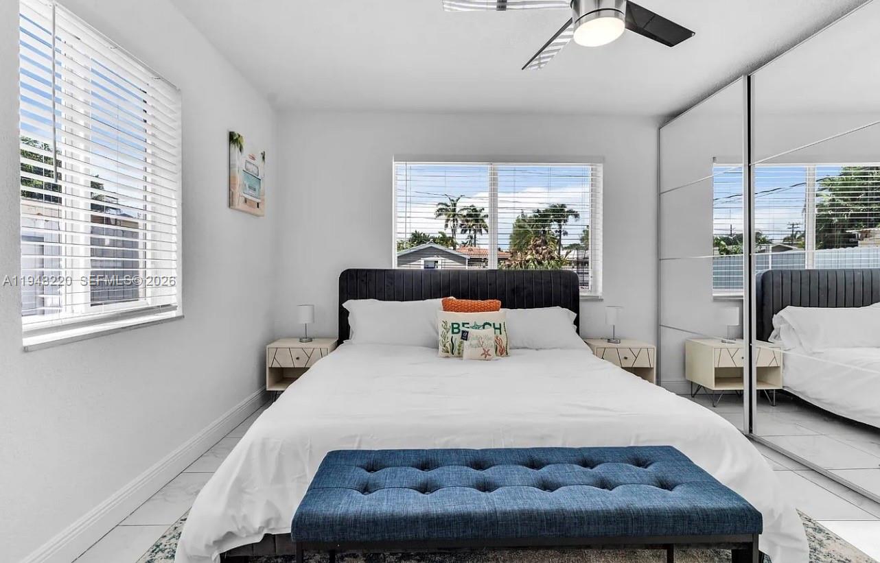 211 Southeast 3rd Street Dania Beach, FL 33004 - Photo 11 of 20 a large bed sitting in a bedroom next to a window