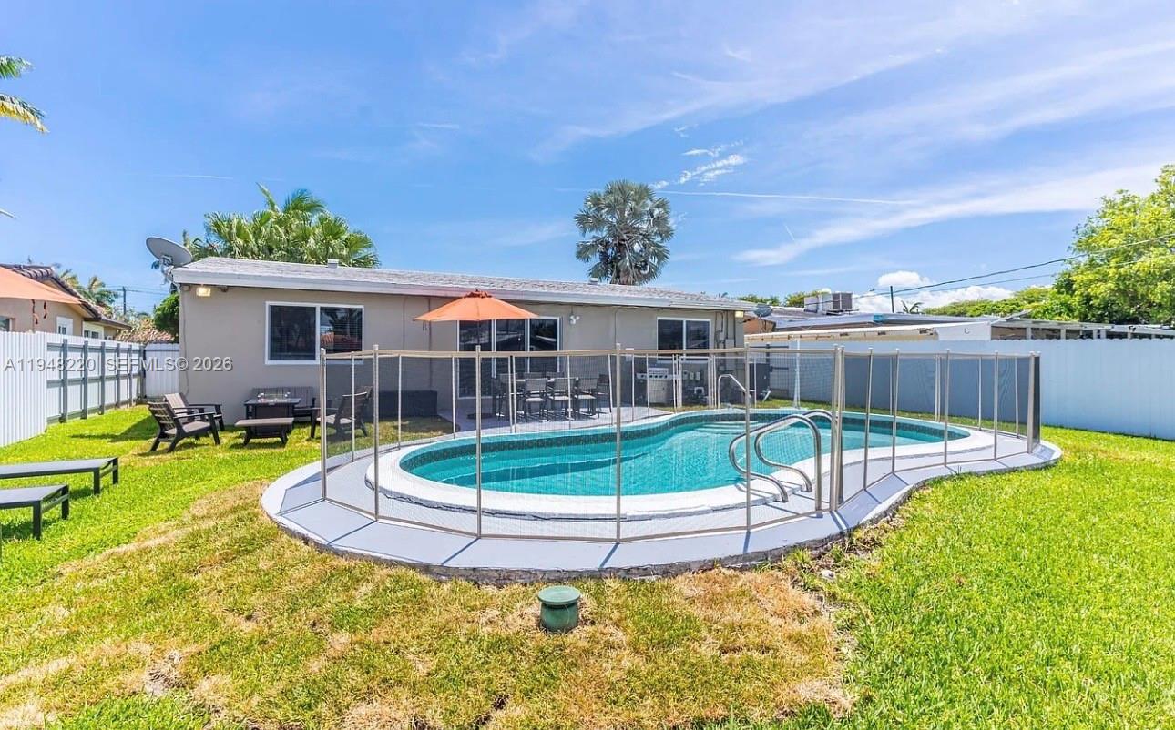 211 Southeast 3rd Street Dania Beach, FL 33004 - Photo 19 of 20 a view of a house with a backyard porch and sitting area