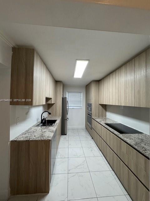 211 Southeast 3rd Street Dania Beach, FL 33004 - Photo 4 of 20 a kitchen with stainless steel appliances granite countertop a sink stove and cabinets