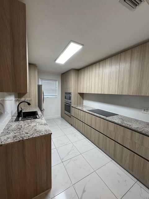 211 Southeast 3rd Street Dania Beach, FL 33004 - Photo 5 of 20 a kitchen with stainless steel appliances granite countertop a sink stove and cabinets