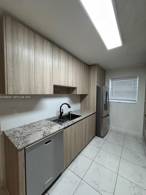 211 Southeast 3rd Street Dania Beach, FL 33004 - Photo 6 of 20 a kitchen with stainless steel appliances granite countertop a sink stove and refrigerator