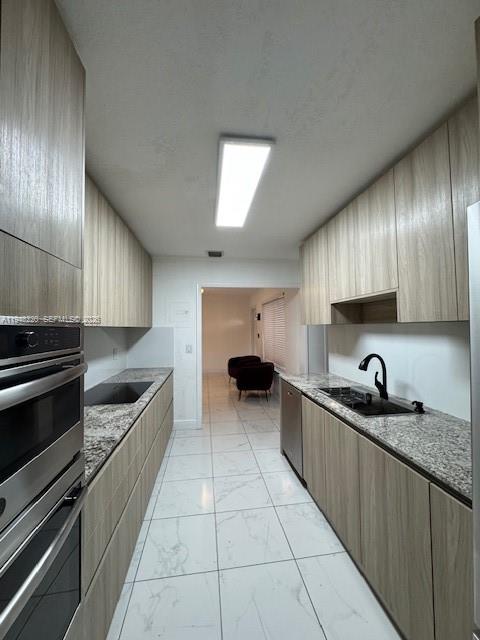 211 Southeast 3rd Street Dania Beach, FL 33004 - Photo 8 of 20 a kitchen with stainless steel appliances granite countertop a sink and a stove