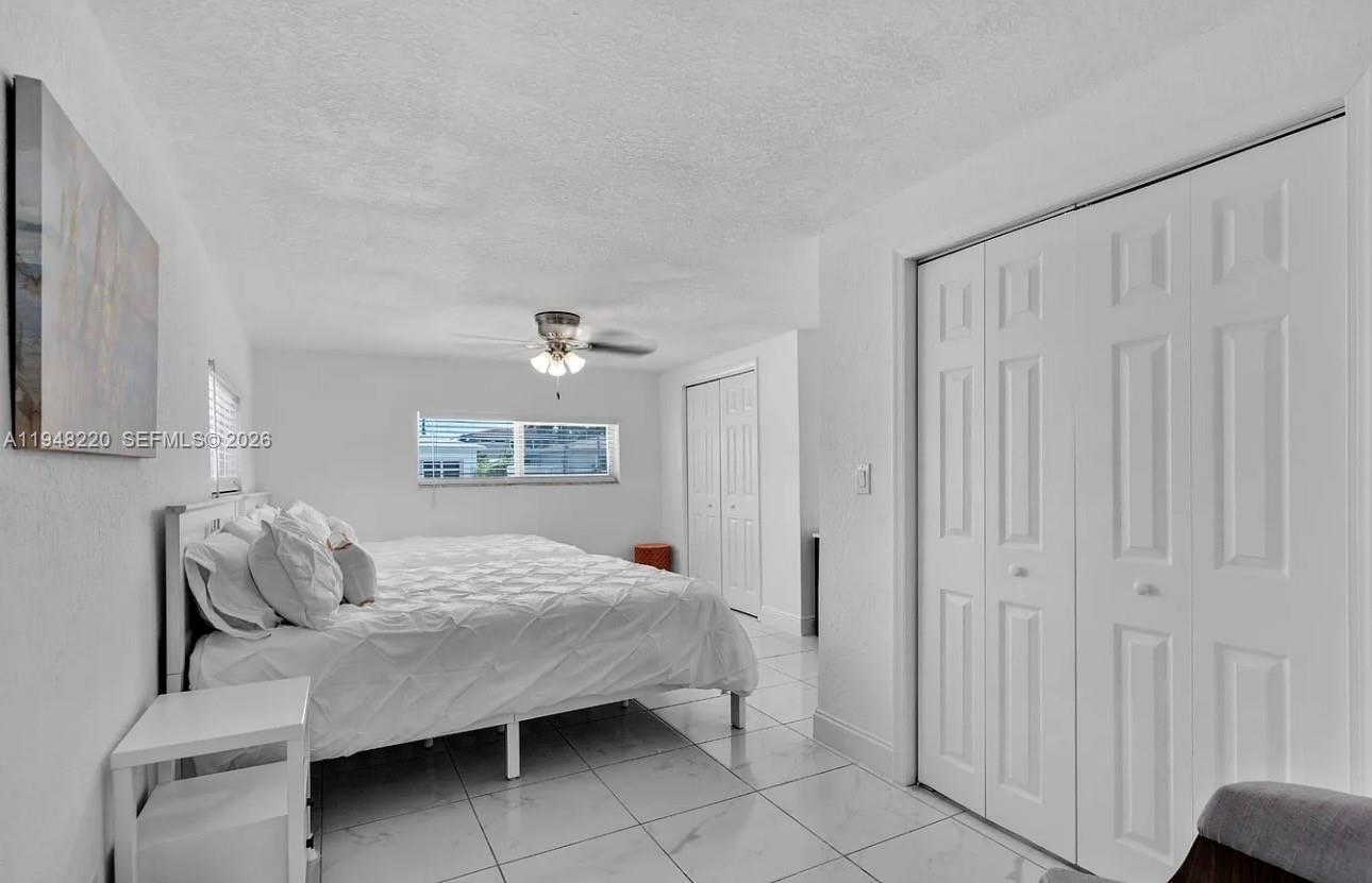 211 Southeast 3rd Street Dania Beach, FL 33004 - Photo 9 of 20 a bedroom with a bed and a window