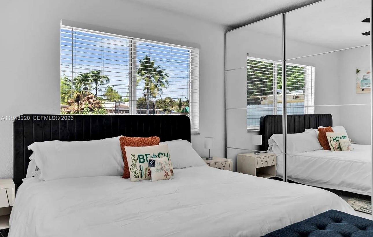 211 Southeast 3rd Street Dania Beach, FL 33004 - Photo 10 of 20 a bedroom with bed and large window