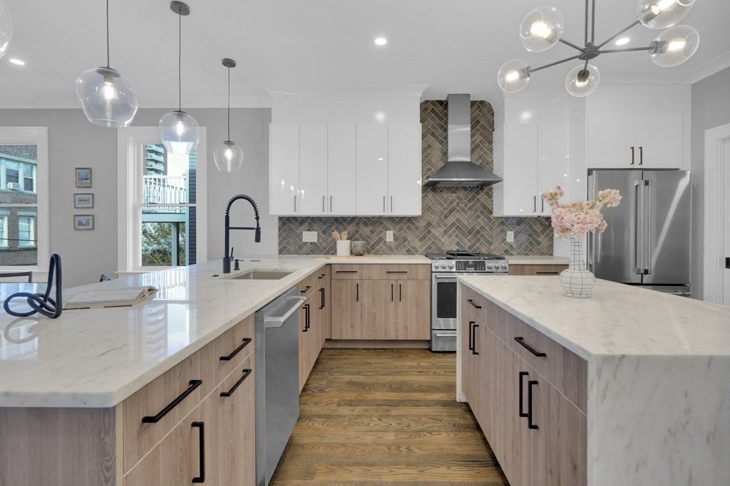 91 Parkton Road, Unit 1 Boston, MA 02130 - Photo 11 of 35 a kitchen with kitchen island granite countertop a sink a counter top space stainless steel appliances and cabinets