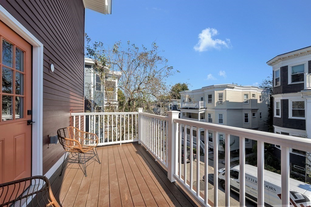 91 Parkton Road, Unit 1 Boston, MA 02130 - Photo 28 of 35 a view of a balcony with a potted plant and wooden fence