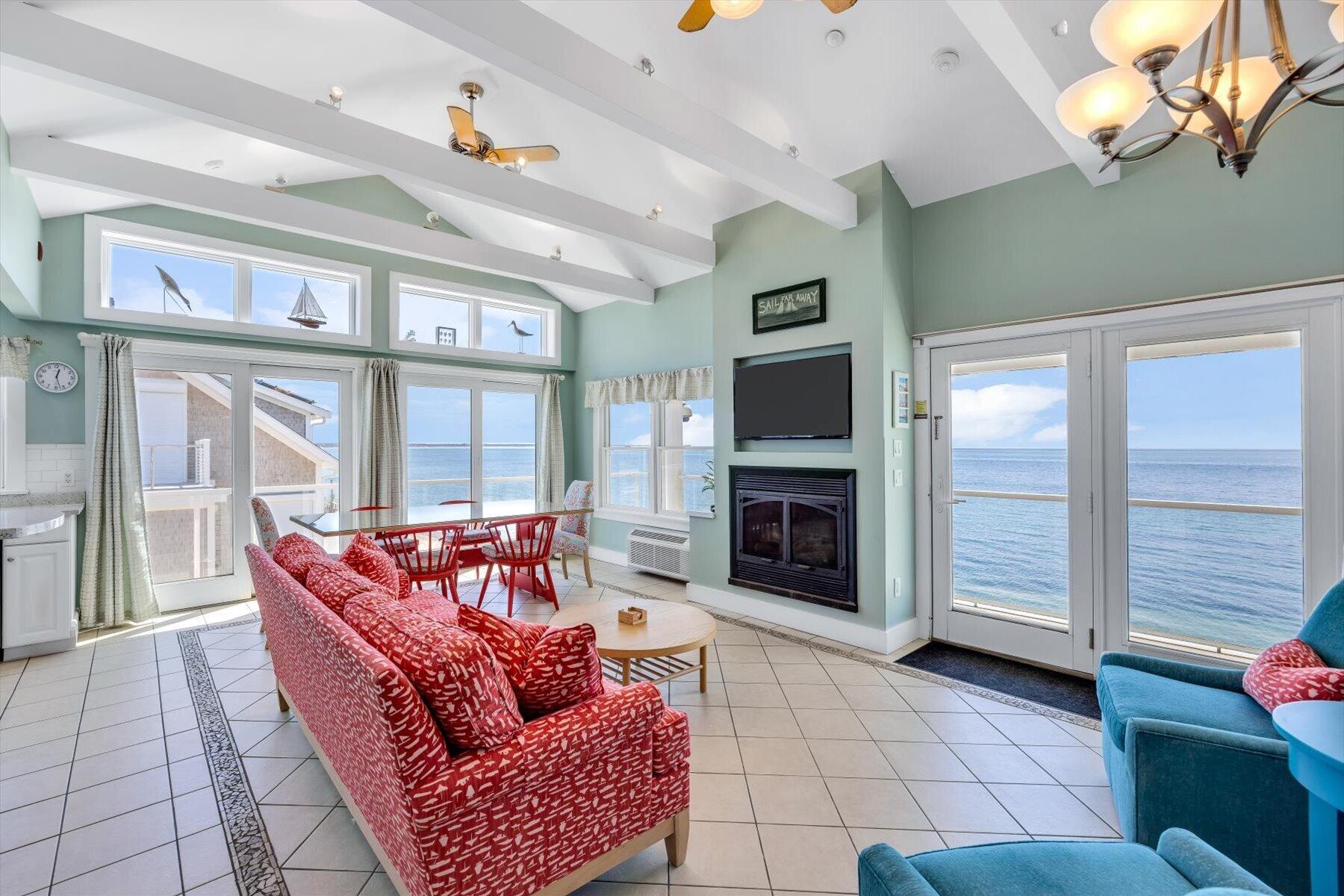 a living room with furniture a flat screen tv and a fireplace