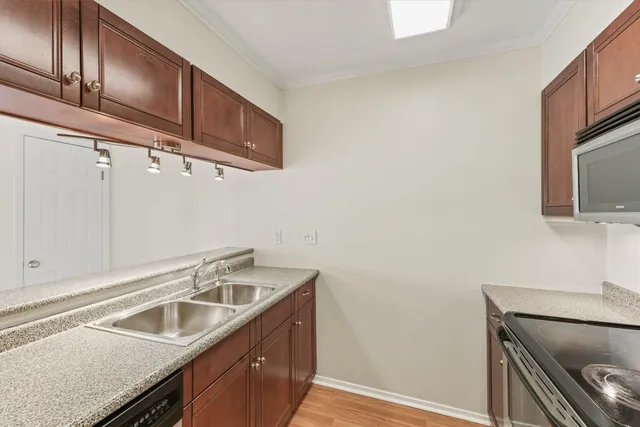 a kitchen with stainless steel appliances granite countertop a sink and a microwave