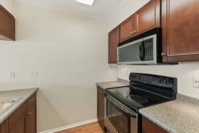 a kitchen with a stove microwave and sink
