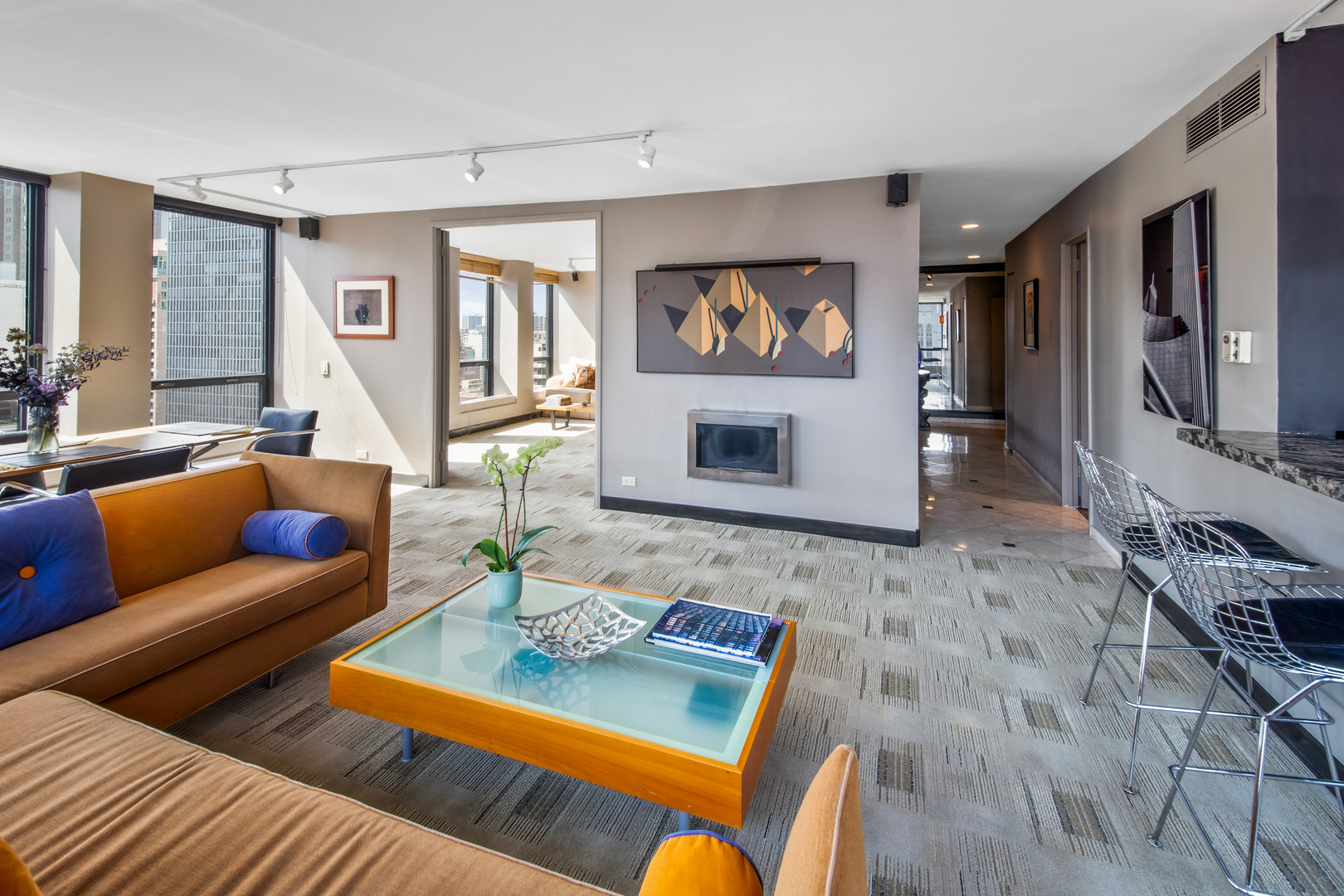 260 East Chestnut Street, Unit 2701 Chicago, IL 60611 - Photo 5 of 38 a living room with furniture flat screen tv and a fireplace