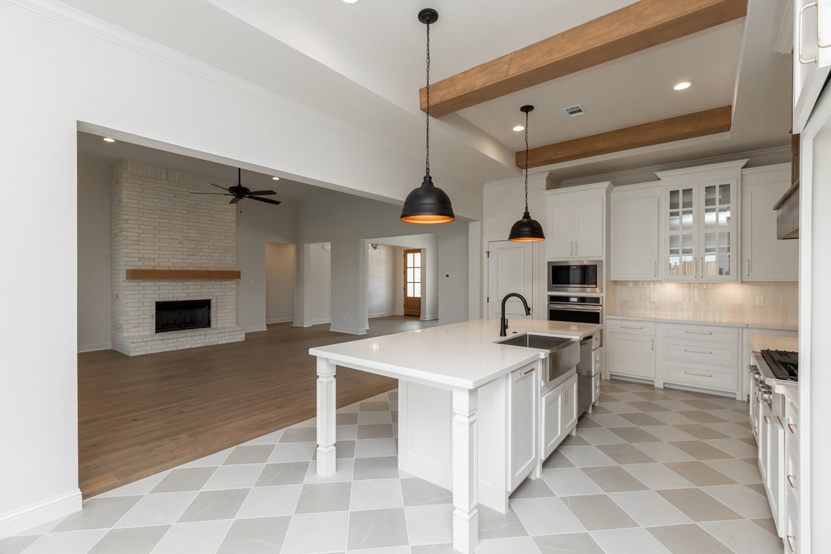 6560 Brayfield Lane Beaumont, TX 77706 - Photo 12 of 38 a kitchen with a stove a sink and a refrigerator