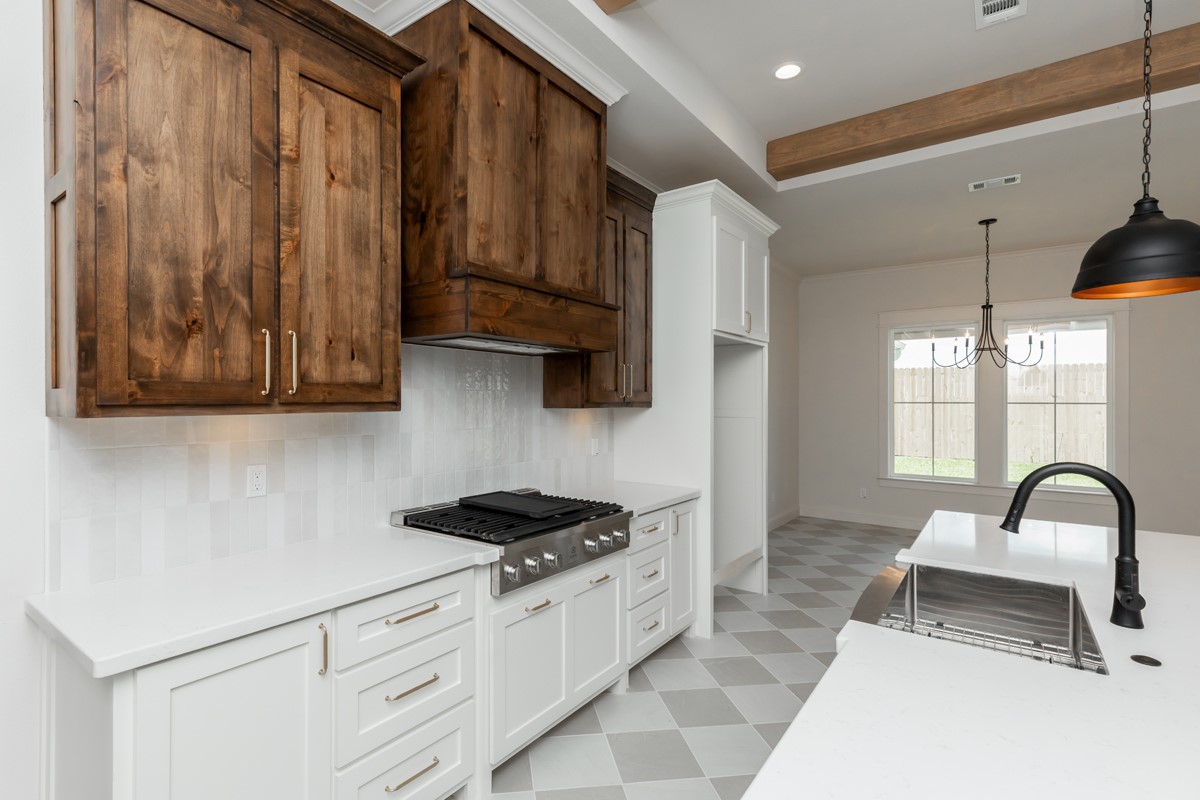 6560 Brayfield Lane Beaumont, TX 77706 - Photo 14 of 38 a kitchen with stainless steel appliances granite countertop a sink stove and cabinets