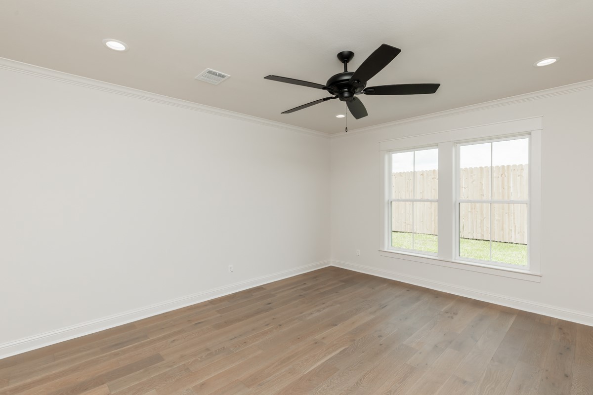 6560 Brayfield Lane Beaumont, TX 77706 - Photo 19 of 38 wooden floor in an empty room with a window
